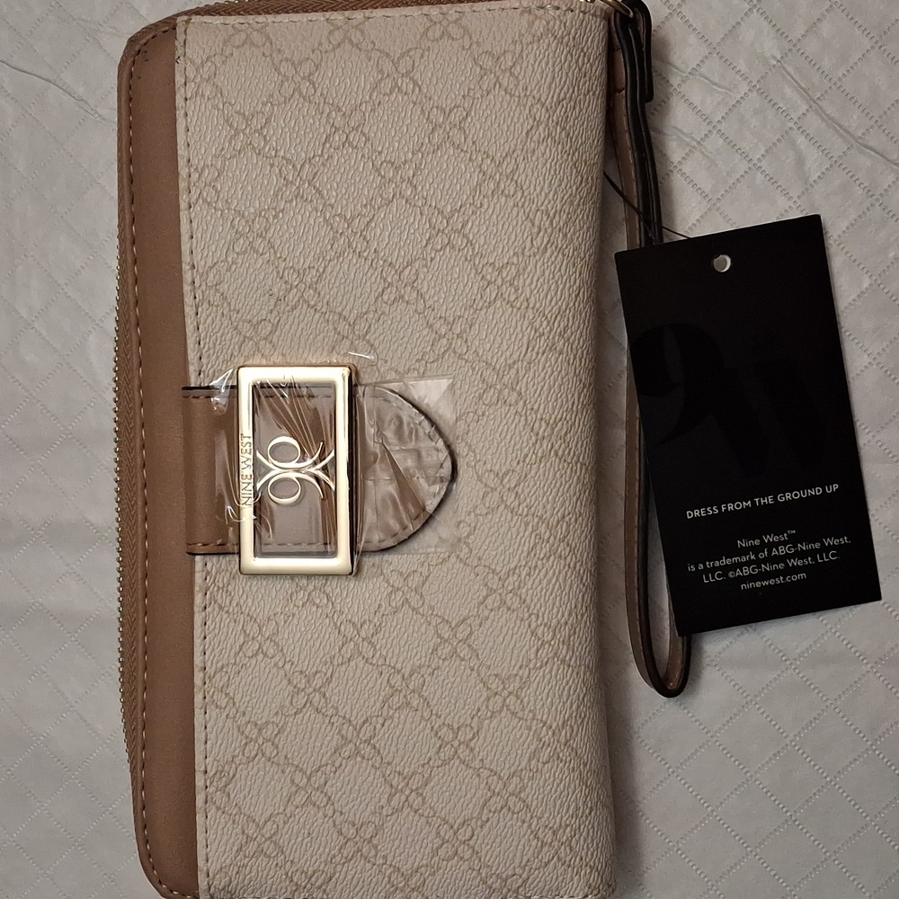 Nine West beige with brown trim wristlet/clutch with zipper closure.